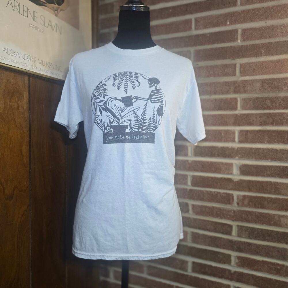 Skeleton Watering Plants Graphic Tee White Small "You Make Me Feel Alive"
